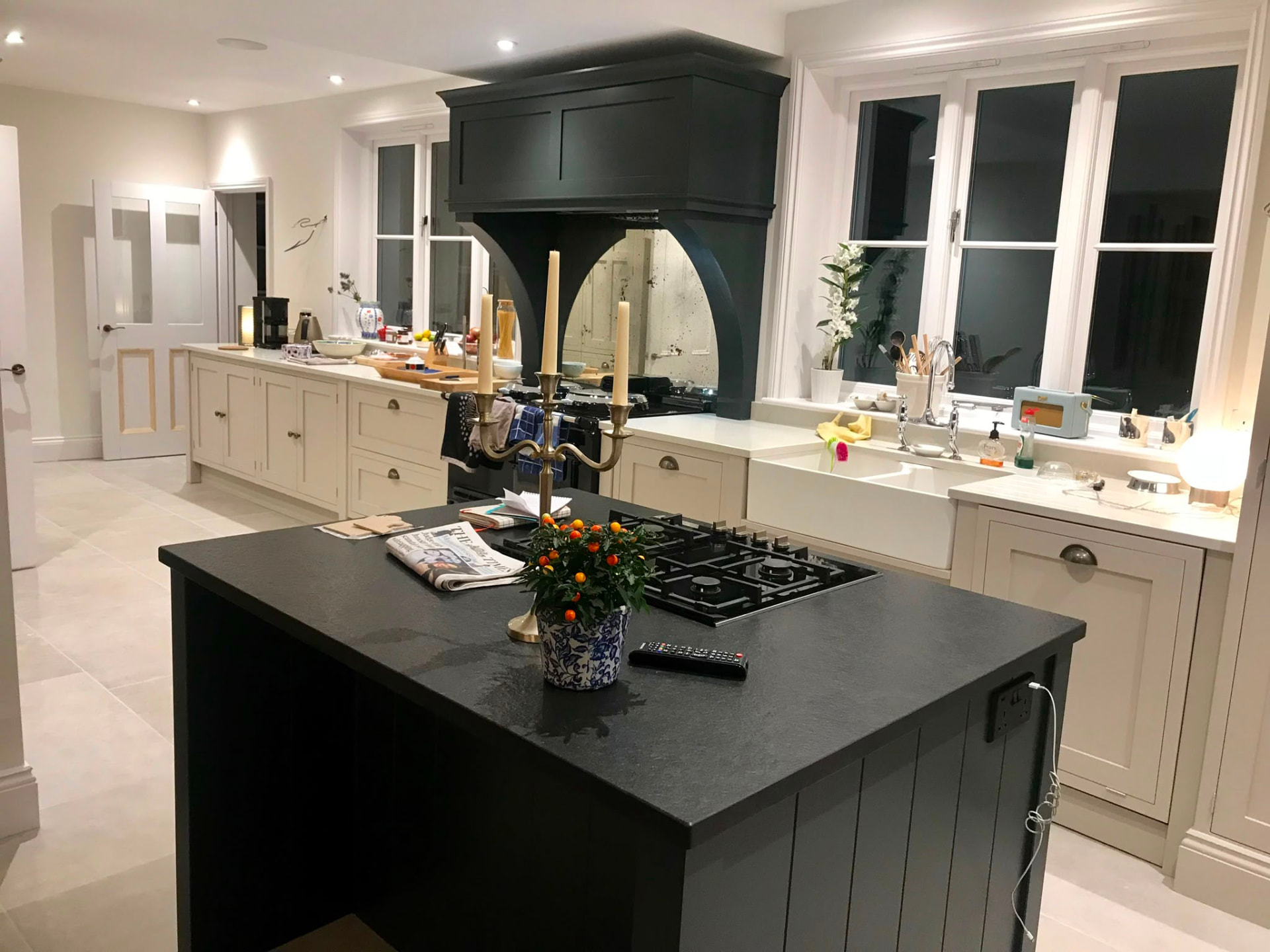 Charcoal hand painted kitchen island and extractor canopy with warm cream cabinetry
