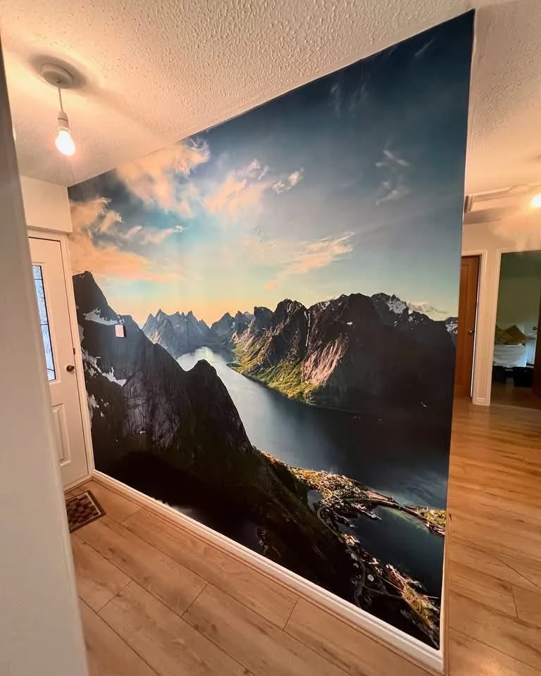 Photographic fjord mural hung as a full-height entrance hall feature wall