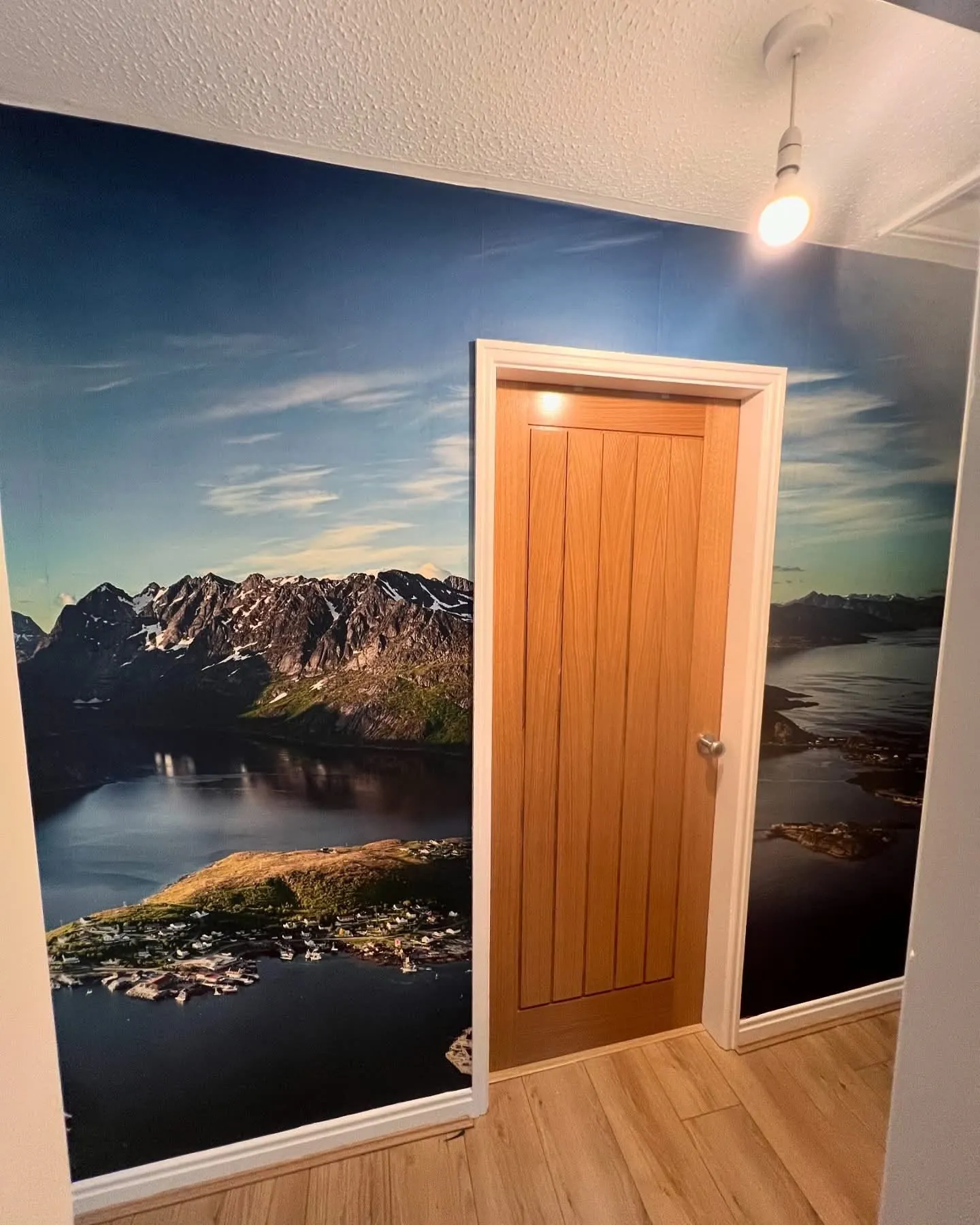 Panoramic fjord landscape mural wallpaper wrapped around a landing doorway