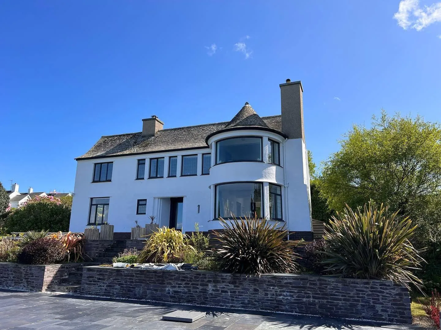White rendered coastal house exterior after repainting