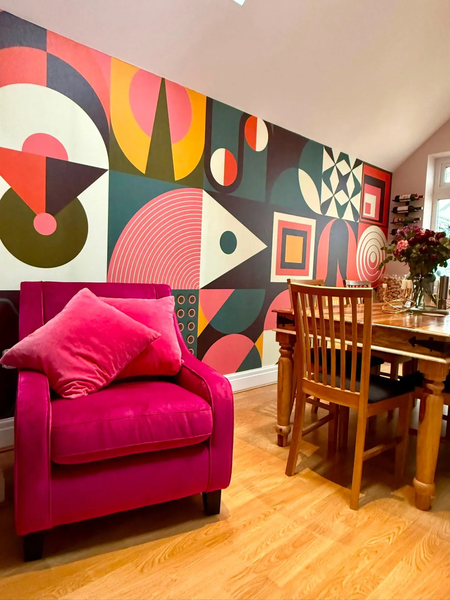 Hand painted geometric feature wall in a dining room