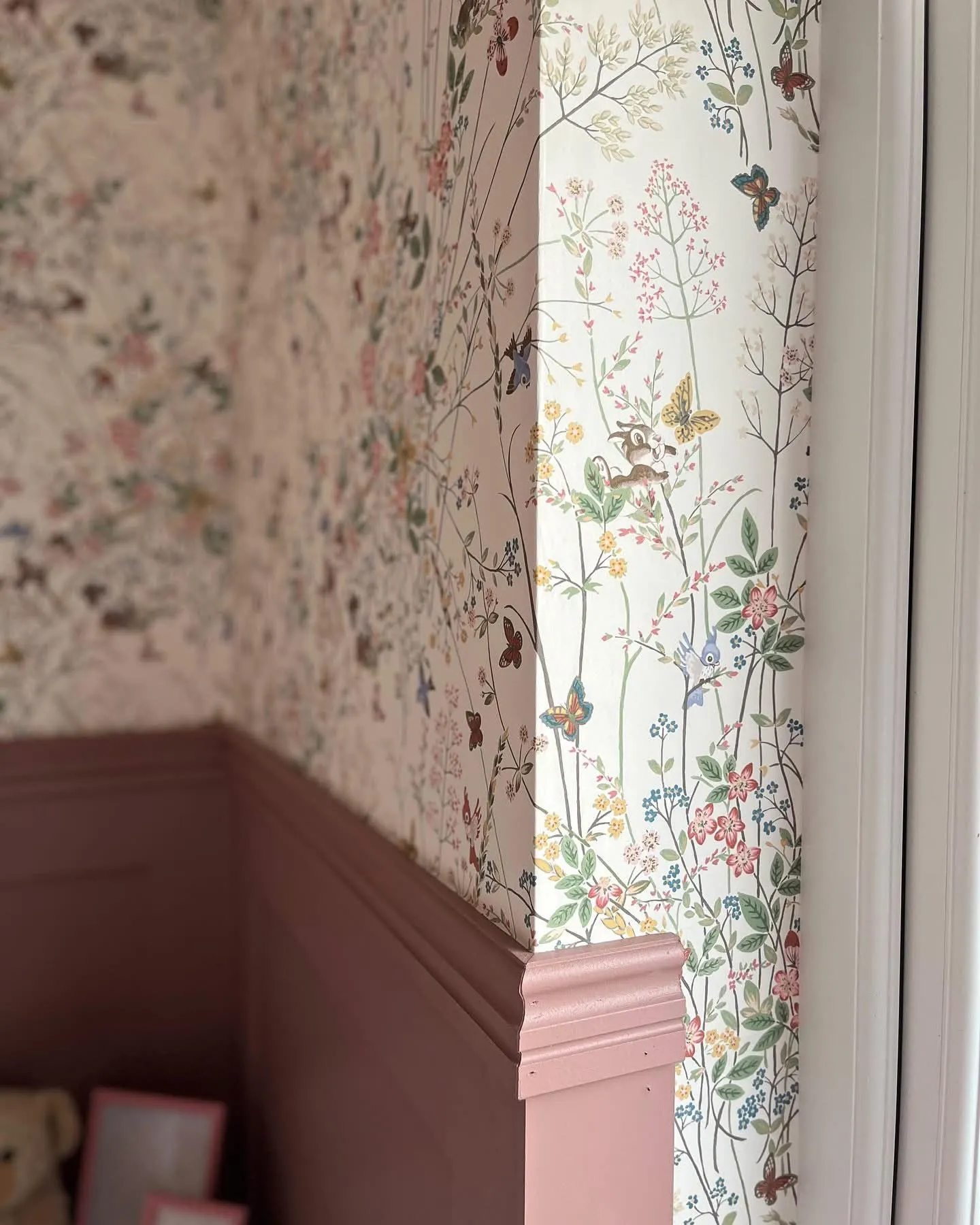 Close detail of meadow wallpaper turned around a window reveal