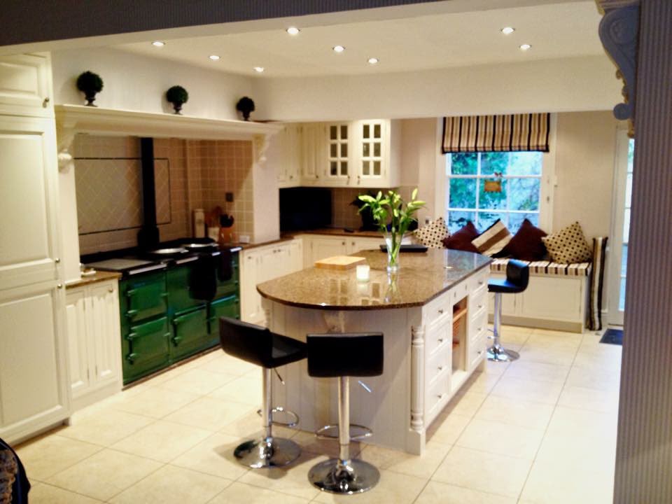 Traditional cream hand painted kitchen with central island and green range cooker